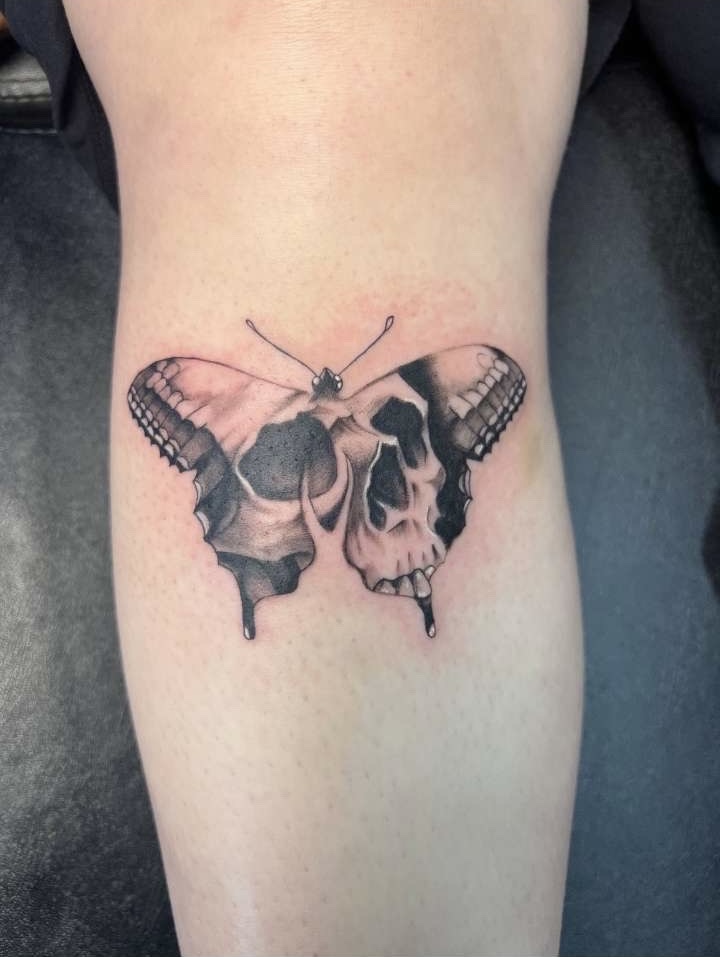 Black and grey skull butterfly calf tattoo