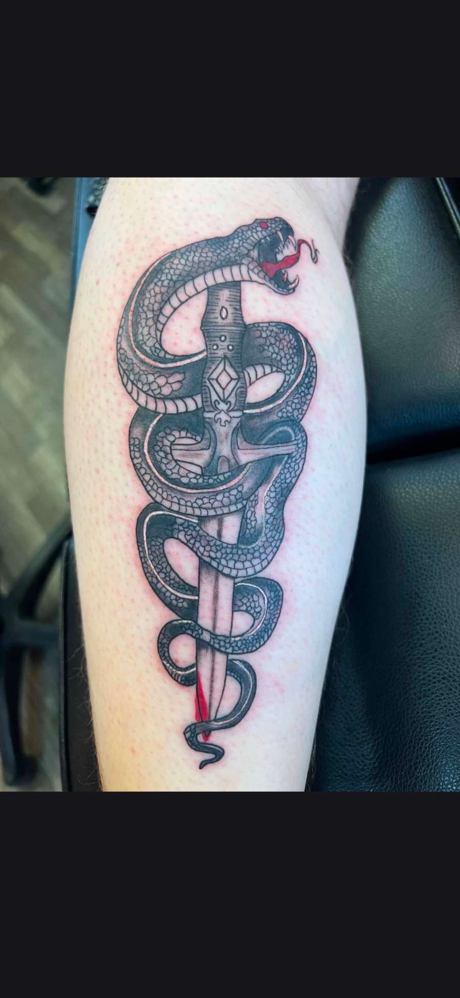 Traditional snake coiled around a dagger calf tattoo