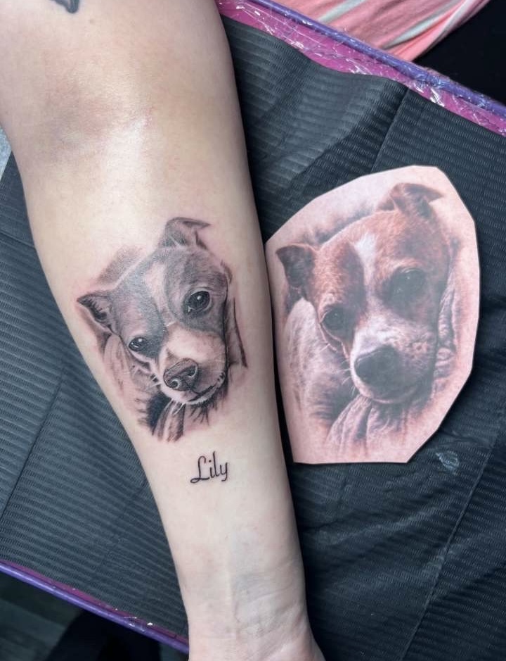 Realistic black and grey dog portrait forearm tattoo with name script Lily