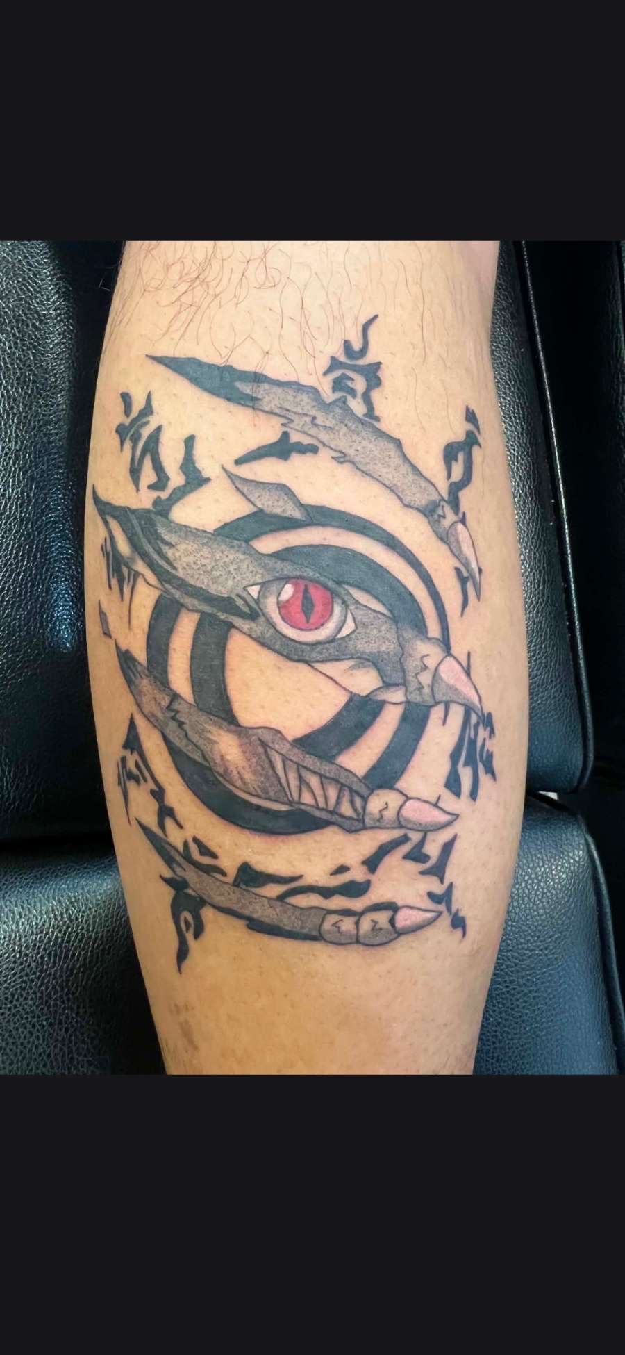 Color dragon eye ripped skin calf tattoo