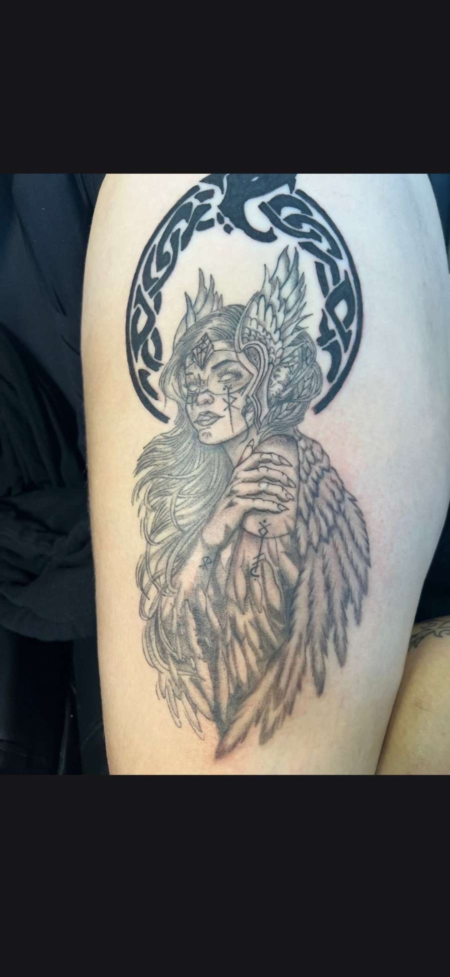 Black and grey valkyrie with feathered wings and Celtic knot halo thigh tattoo